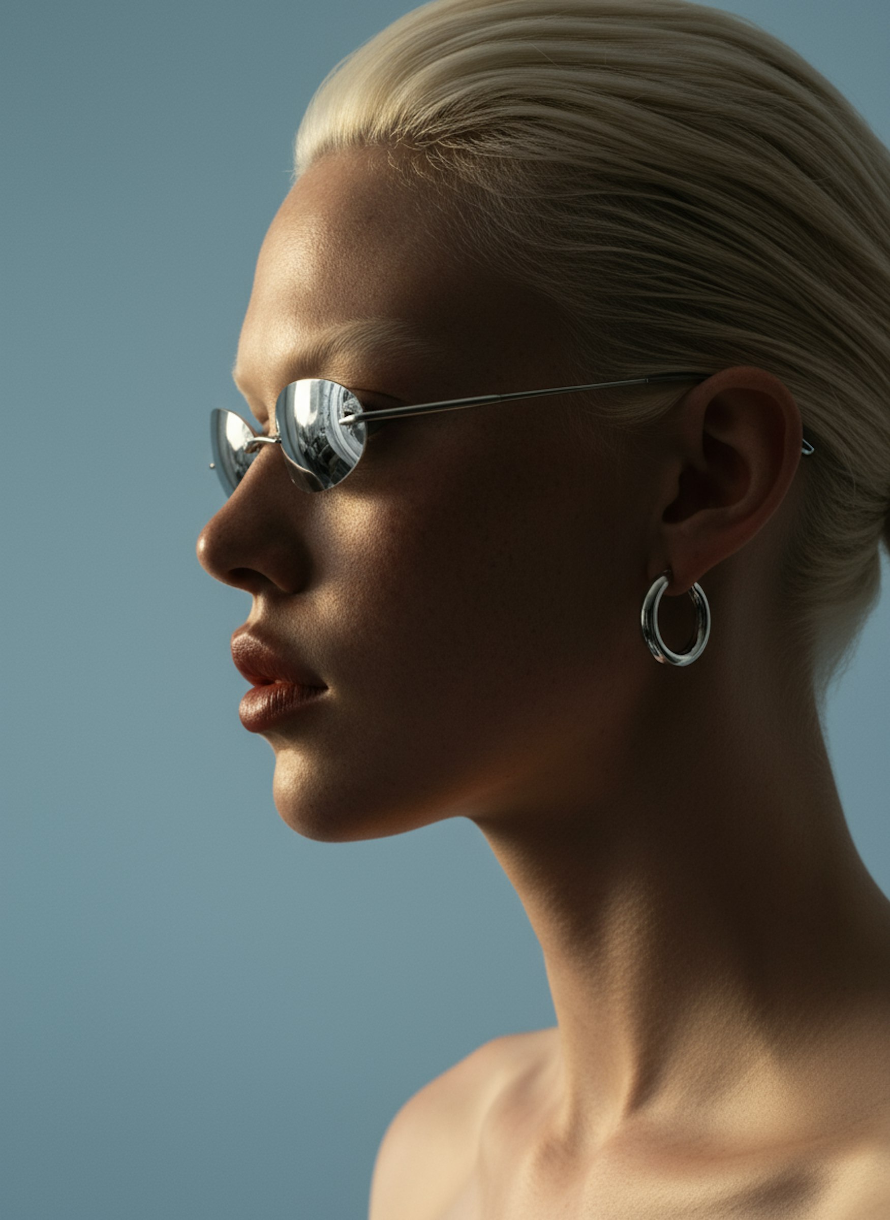 Model in profile wearing black square sunglasses